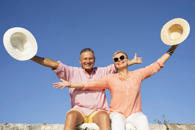 Couple standing on a cliff overlooking the Baja coast