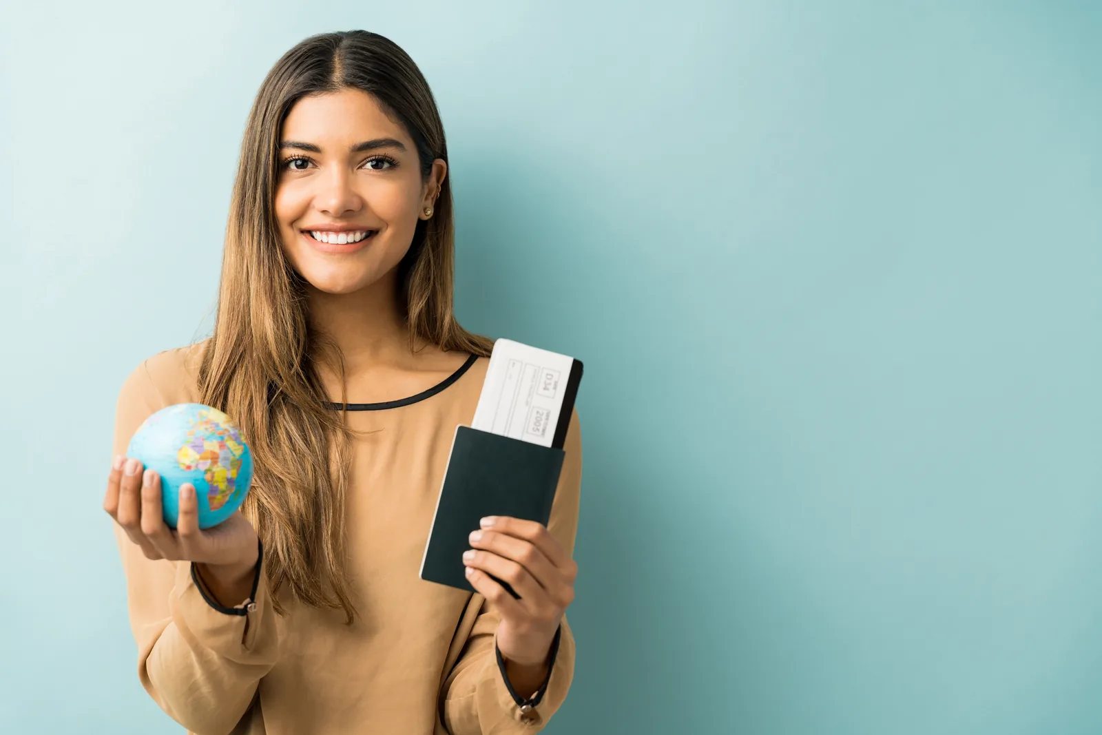 Woman holding a globe and passport — Fast Mex Residency immigration services in Baja California Sur