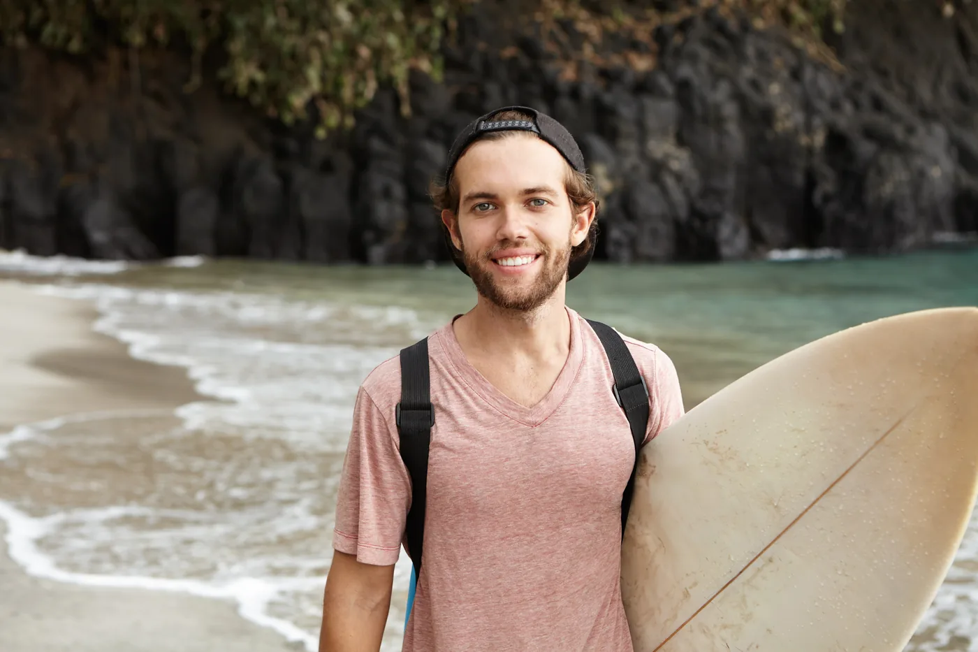 Surfer walking on the beach in Baja California Sur — digital nomad lifestyle